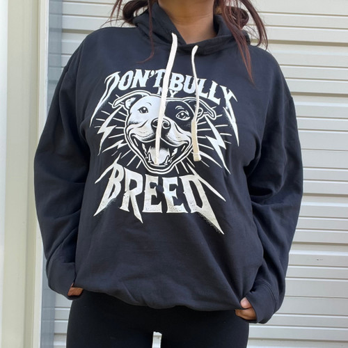 A woman wearing a graphic hoodie from our shop