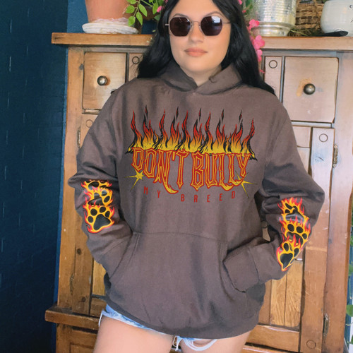 A woman wearing a graphic hoodie from our shop