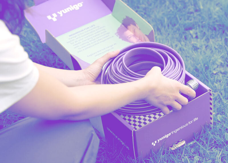 a person placing a garden hose on a table