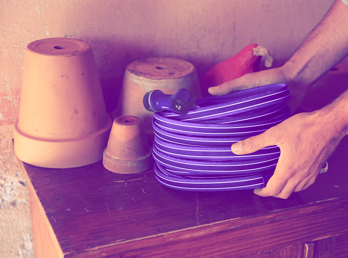 a person placing a garden hose on a table