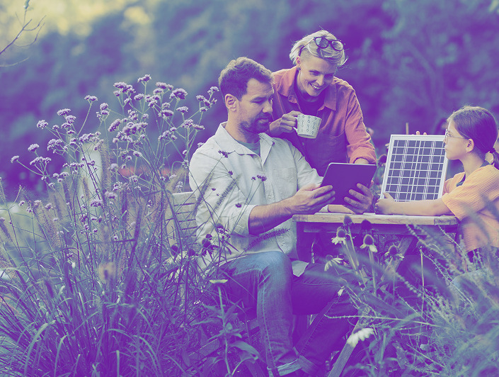 a family sitting at the table in the garden