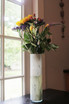 White glass cylinder vase with spring flowers