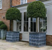Square Sienna Planters flanking doorway
