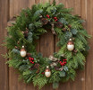 Miniature Acorn ornaments decorating front door wreath