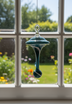 Dew Drop Pyrex Glass Ornament in teal & white in window