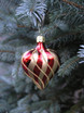 Blown glass red heart ornament with gold stripes on tree