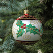 Blown glass ball ornament with holly leaf design