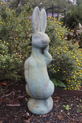 Silly Bunny statue in copper rust finish frong