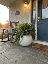 Artemis planter in white finish on front porch near rocker