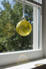 Gold Ball Ornament hanging in window