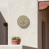 Concrete Sun Plaque on adobe house wall