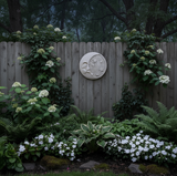 Concrete crescent moon with stars round plaque on fence in moon garden Concrete crescent moon with stars round plaque on fence in moon garden