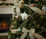 Sheep ornament with glitter on decorated Christmas tree