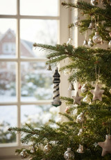 black and white blown glass lighthouse ornament on Christmas tree