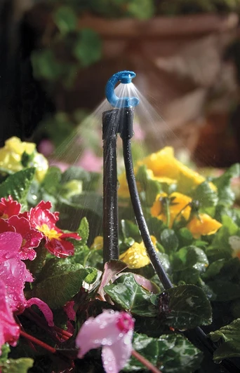 Antelco C-Frame Downspray Assembly in blue watering colorful garden flowers
