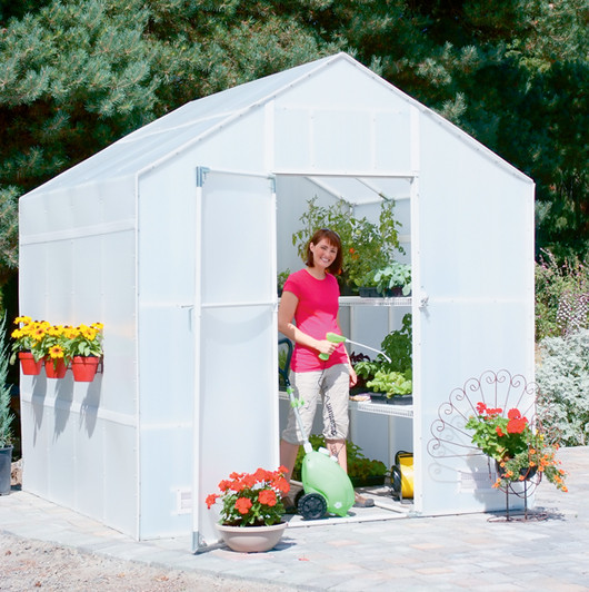 Solexx Garden Master Greenhouse person standing in the open doorway.