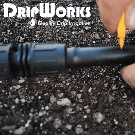 DripWorks Key Punch being used to puncture black poly drip irrigation tubing MPN: PUKEY