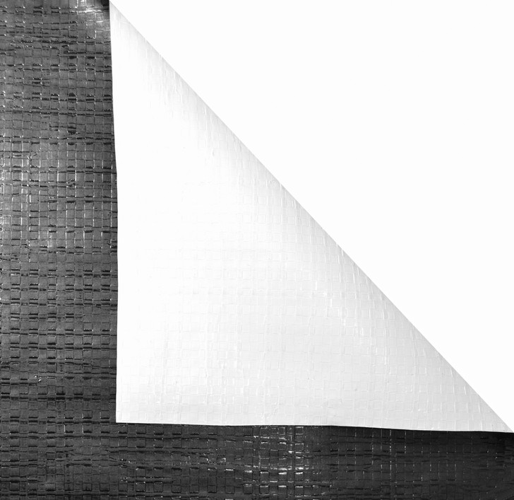 Black/White 12 Mil Cover corner folded back showing white and black sides.