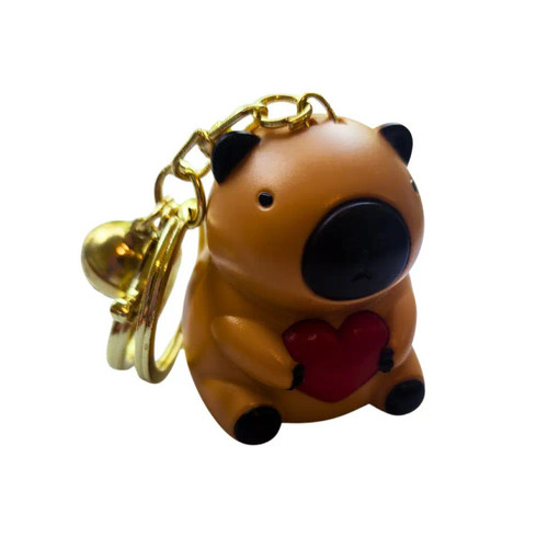Cute capybara talking keychain holding a red heart with gold keyring accessory and collectible animal toy packaging.