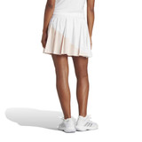 Back lifestyle view of the women's white wonder quartz adidas pleated skirt