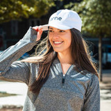 Model posing the erne Unstructured Brushed Poly 5 Panel Hat in the color White.