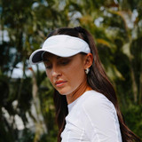 Female model wearing the Selkirk x Parris Todd Visor in the color White.