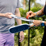 Pickleball players using the GAMMA Pickleball Paddle Cleaning Block.