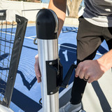 The Dominator Pro Portable Pickleball Net crank being used on a pickleball court