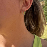 View of the Green Born to Rally Color Pop Pickleball Paddle Stud Earrings on model.