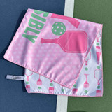 View of the Pink Born to Rally Dink Responsibly Double-Sided Microfiber Towel displayed on pickleball court.