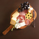 Large Pickleball Paddle Charcuterie board with meats, cheeses, and fruit