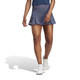 Lifestyle view of Woman's adidas Club Pleatskirt in the color Shadow Navy.