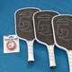 GAMMA Pickleball Paddle Cleaning Block next to 3 paddles.