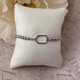View of the Silver Born to Rally Pickleball Paddle Beaded Stretch Bracelet displayed on pillow.