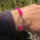 View of the Pink Born to Rally Pickleball Paddle Adjustable Rope Bracelet on writst.