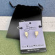 View of the Born to Rally Pickleball Pearl Stud Earrings with packaging, and included drawstring bag,