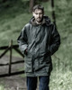 Dog walker wearing Hoggs of Fife Woodsman wax jacket in the rain for reliable waterproof protection Dog walker wearing Hoggs of Fife Woodsman wax jacket in the rain for reliable waterproof protection