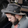 Man with beard wearing the Hoggs of Fife Caledonia waxed hat whilst working