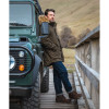Man wearing Hoggs of Fife Argyll II jacket forest green leaning against land rover dog walking coat