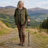 Brown Leather Adjustable Shooting Stick with Rubber Ferrule being used on a compact countryside path by a walker wearing traditional country clothing.