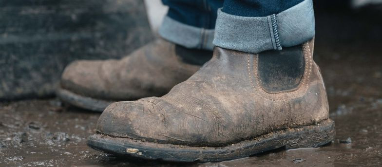 Dealer boots in muddy farm yard providing grip and comfort for daily work