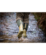 Man wearing Jack Pyke Ashcombe neoprene wellington boots walking through stream on a shoot day