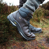 Man wearing Grisport Fuse waterproof walking boots on grassy path