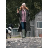 Hoggs of Fife Ardross Pro Ladies Long Riding Coat in olive, worn outdoors with a dog