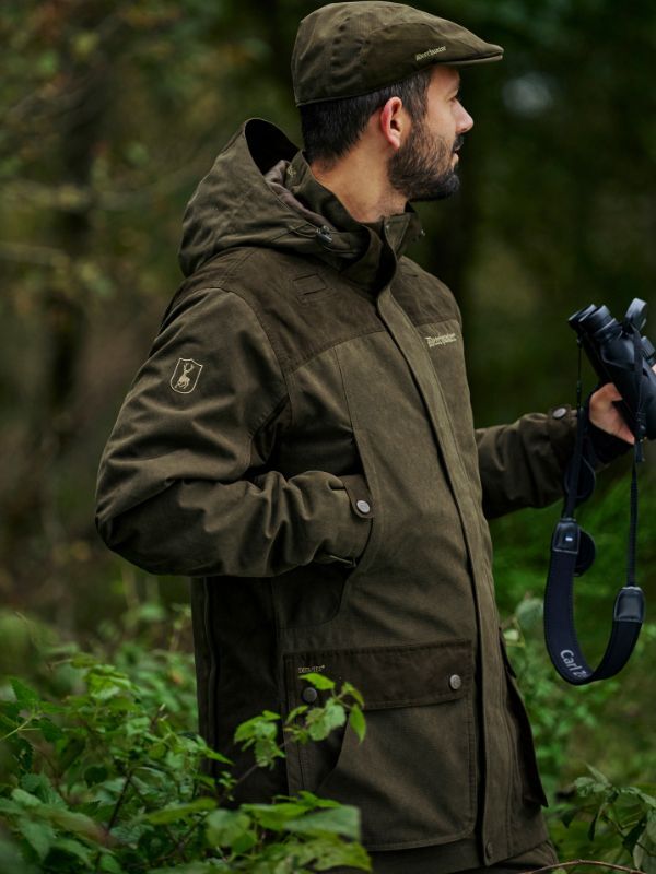 Man wearing Deerhunter jacket in forest
