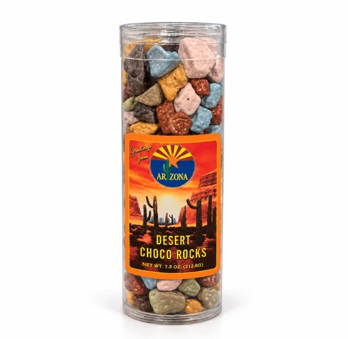 Clear cylindrical container filled with colorful, rock-shaped chocolate candies. The container features an Arizona-themed label with a vibrant desert sunset, red rock formations, saguaro cacti, and Arizona lettering. Net weight 7.5 oz (212.6 g).