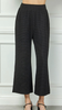 Wide leg black pants with textured fabric and elastic waistband