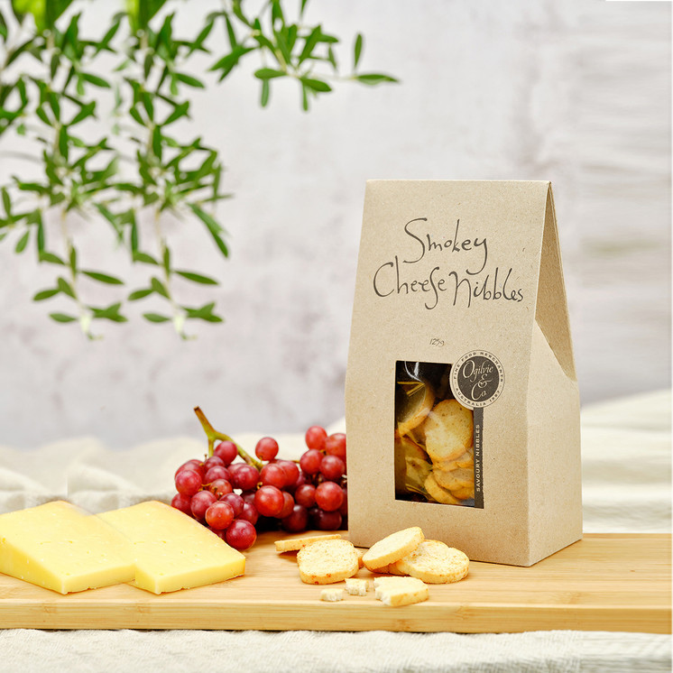 Curated gourmet hamper including red wine, nuts, and sweet treats