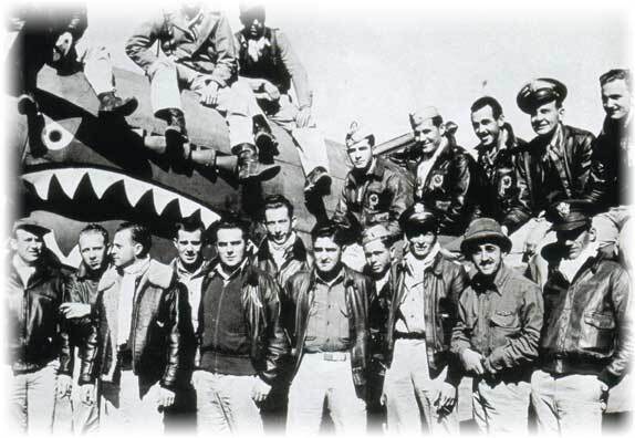 Flying Tigers personnel with a P-40 Warhawk shark-mouth nose art