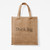 Burlap tote bag laying flat with text "Think big."